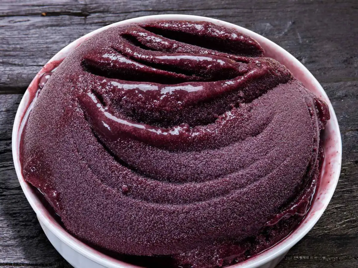 Thick purple acai puree swirled in a white bowl.