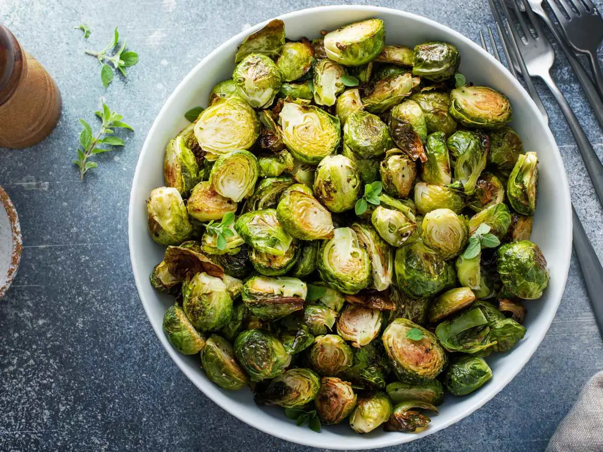 A roasting pan filled with browned Brussels sprouts