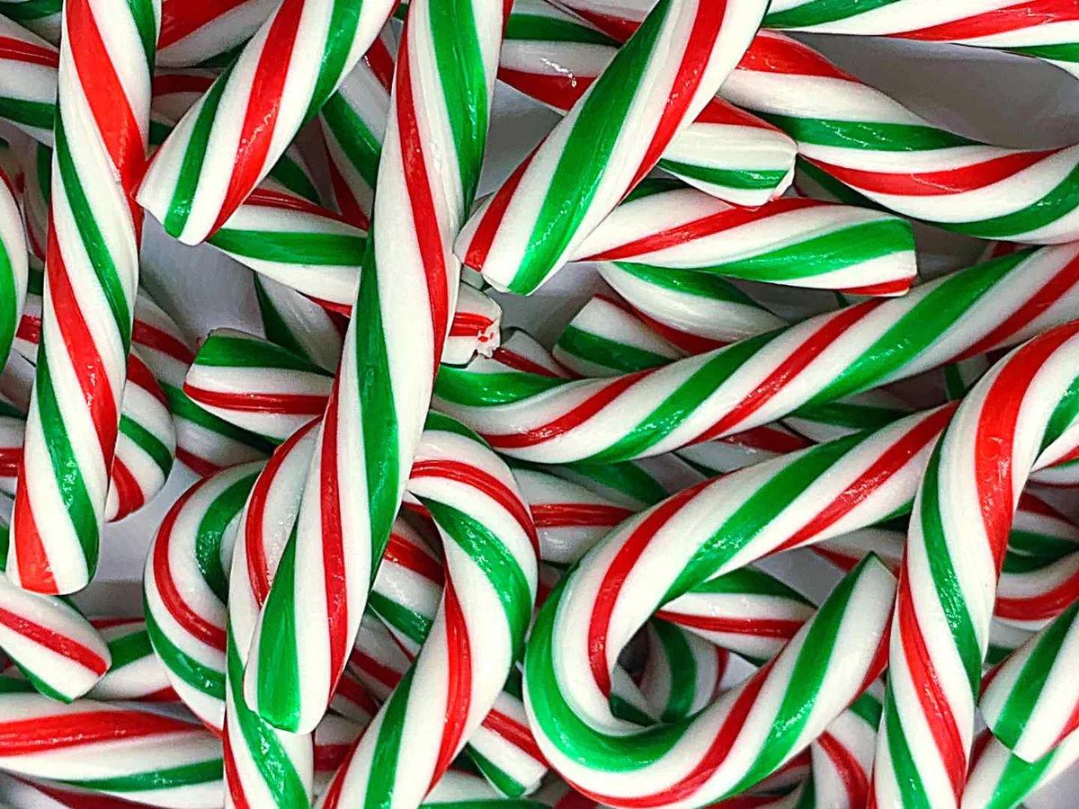 Red, white, and green striped candy canes filling the frame