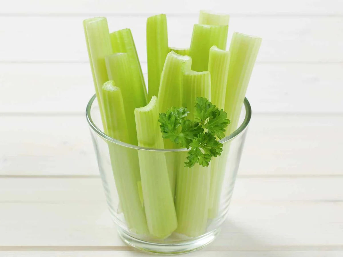Cut celery sticks standing upright in a clear drinking glass