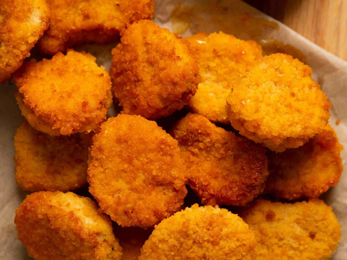 Breaded chicken nuggets on brown paper