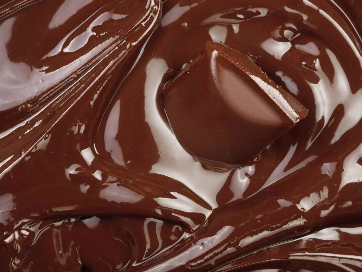 Glossy melted dark chocolate filling the frame