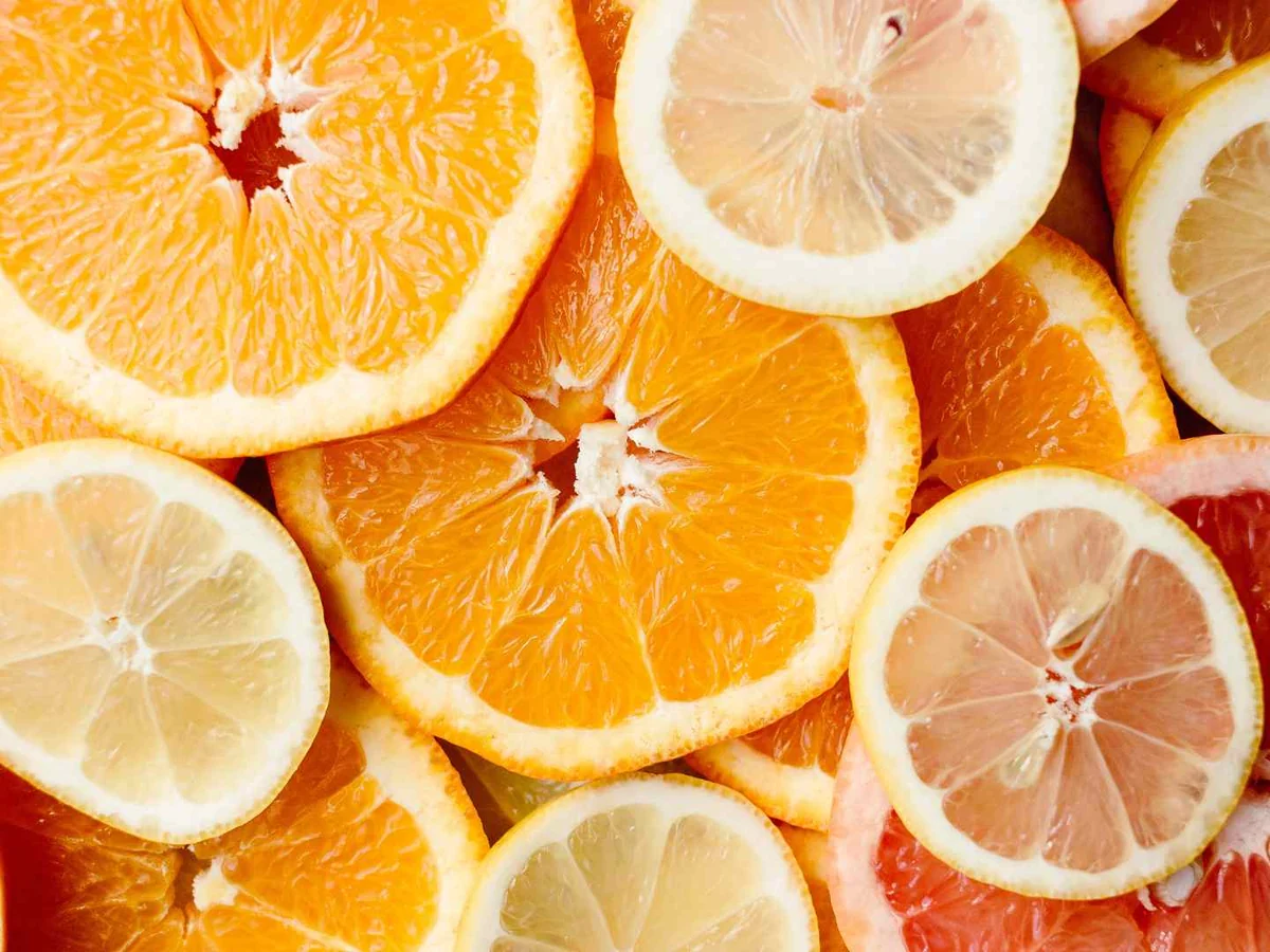 Overlapping slices of orange, lemon, grapefruit, and lime