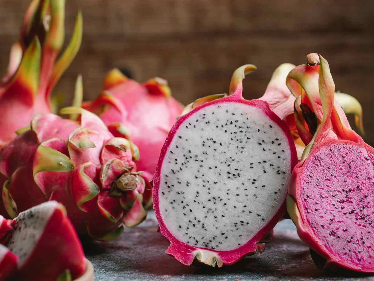 Whole and halved pink dragon fruit