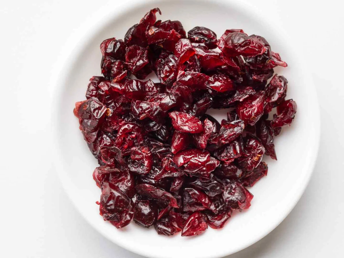 Dried cranberries piled on a white plate