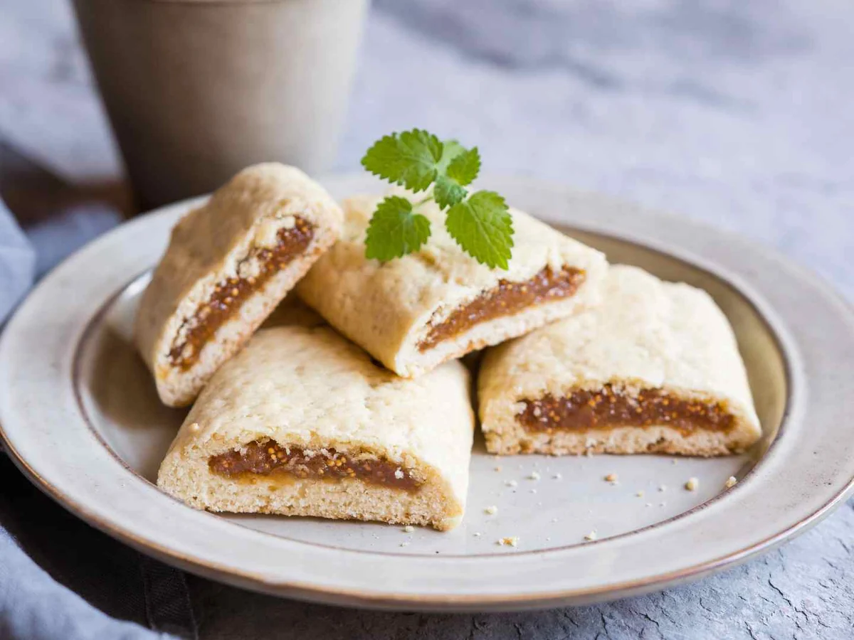 Fig-filled cookies arranged on a gray plate