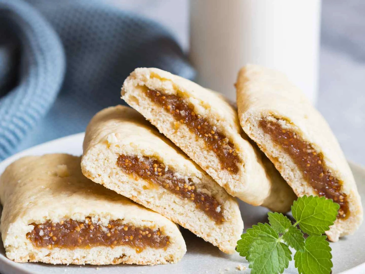 Fig-filled cookies stacked in a white bowl