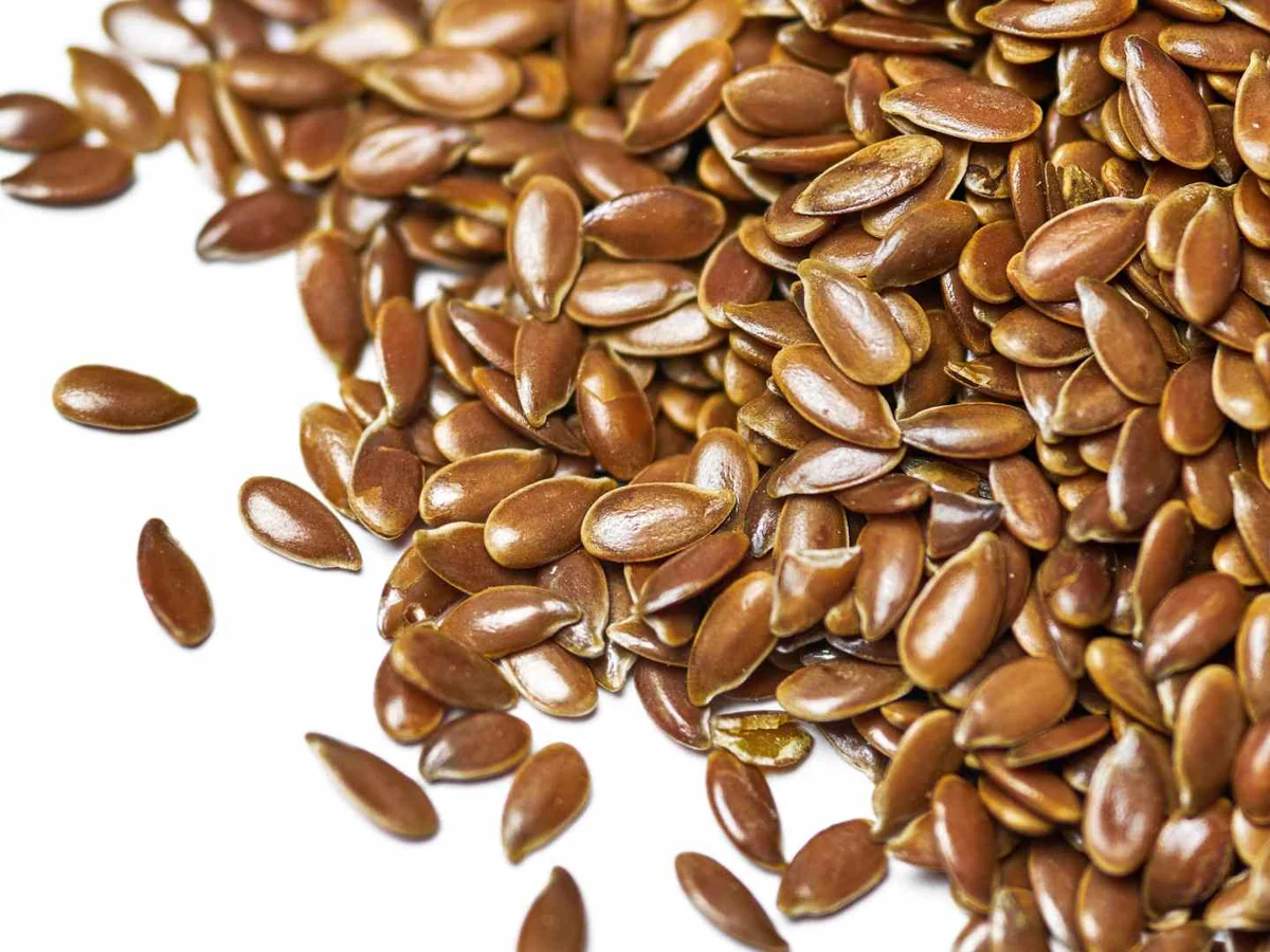 Glossy brown flaxseeds filling the frame