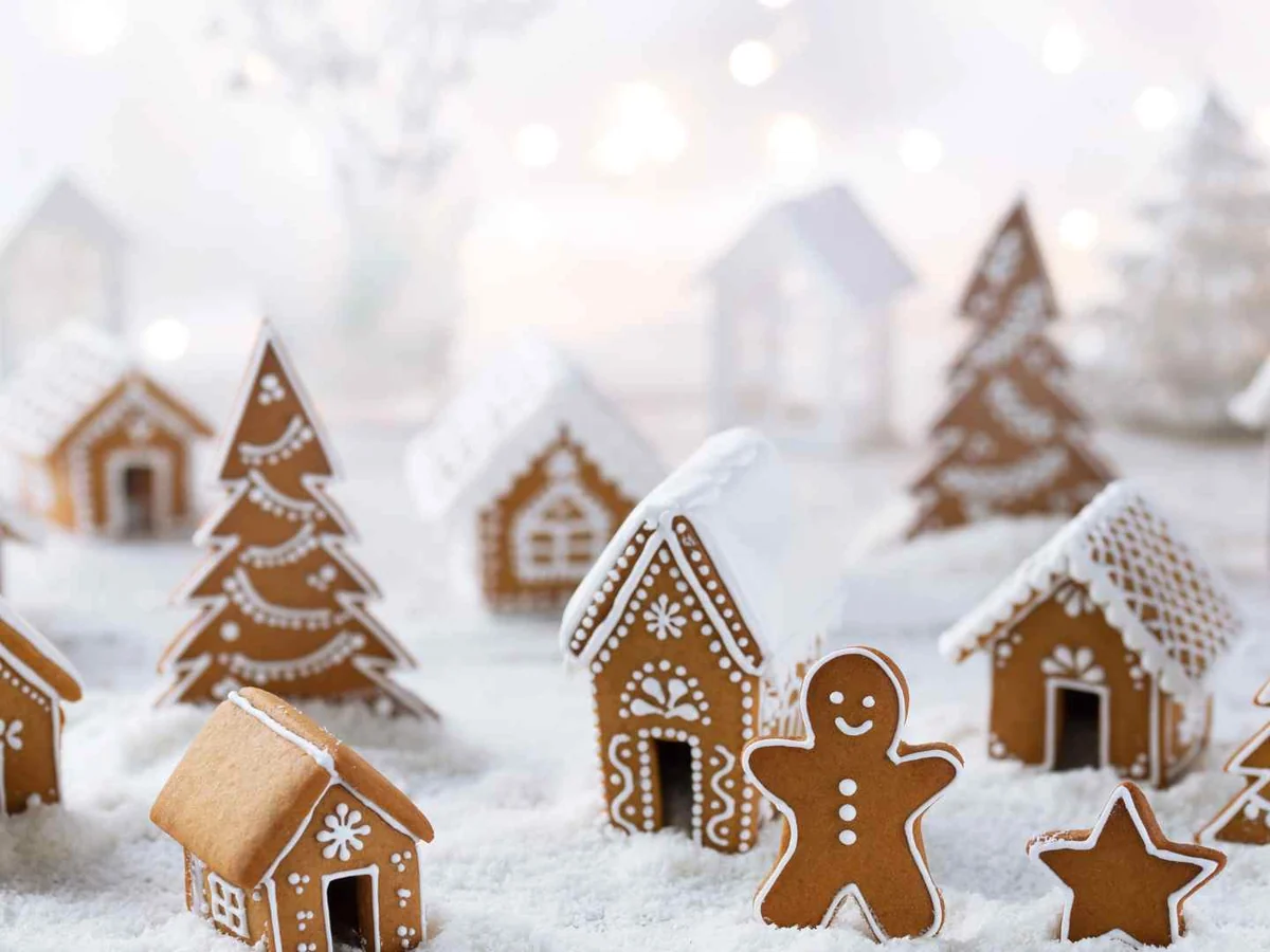 A miniature gingerbread village in a snowy display