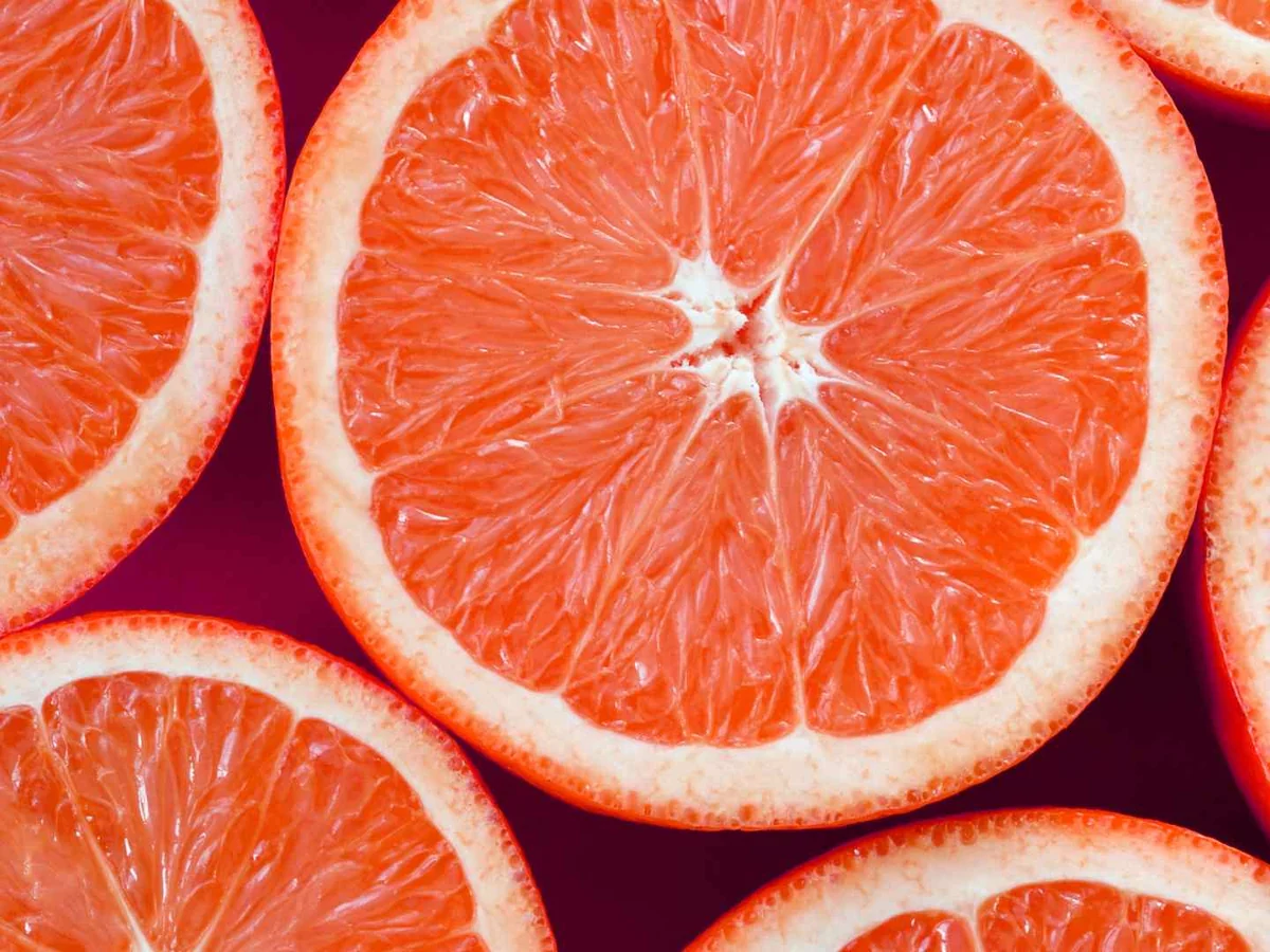 Overlapping pink grapefruit slices filling the frame