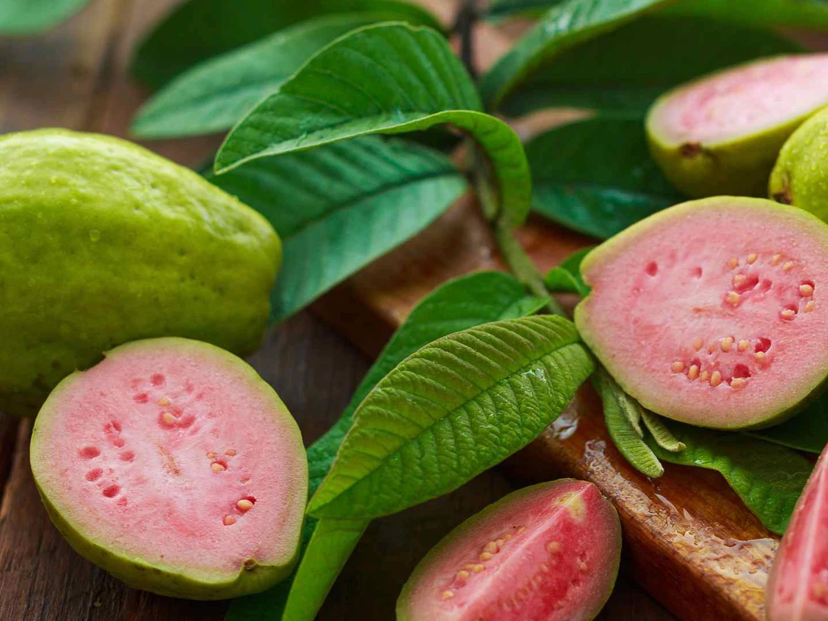 Whole pale green guavas filling the frame.