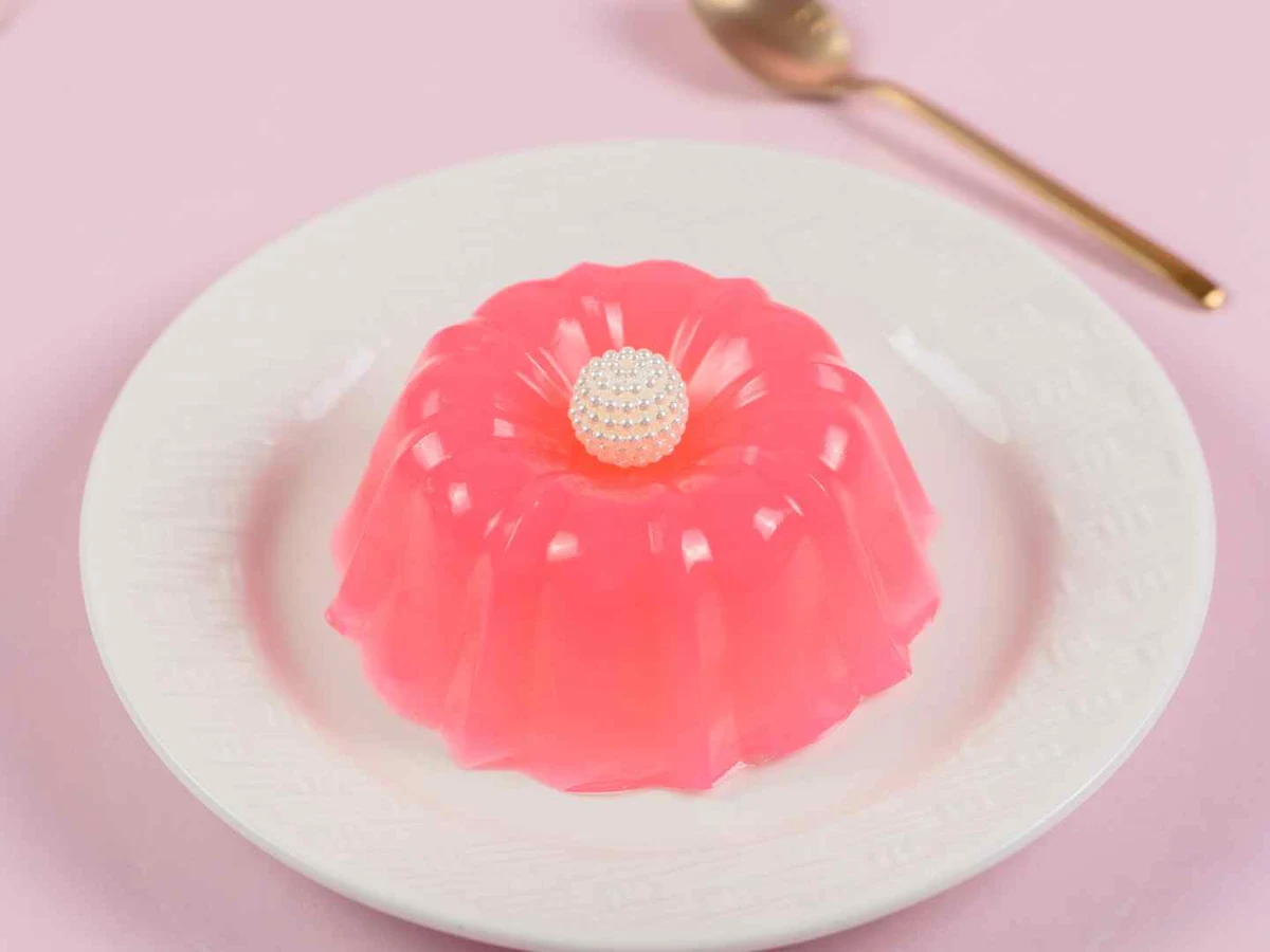 Red, yellow, green, and dark gelatin desserts arranged together.