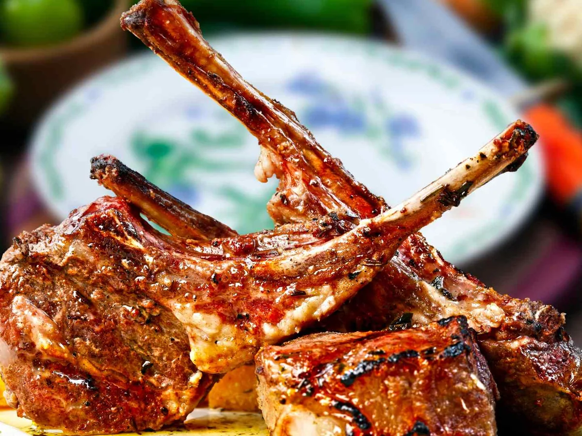 Three grilled lamb chops on a plate