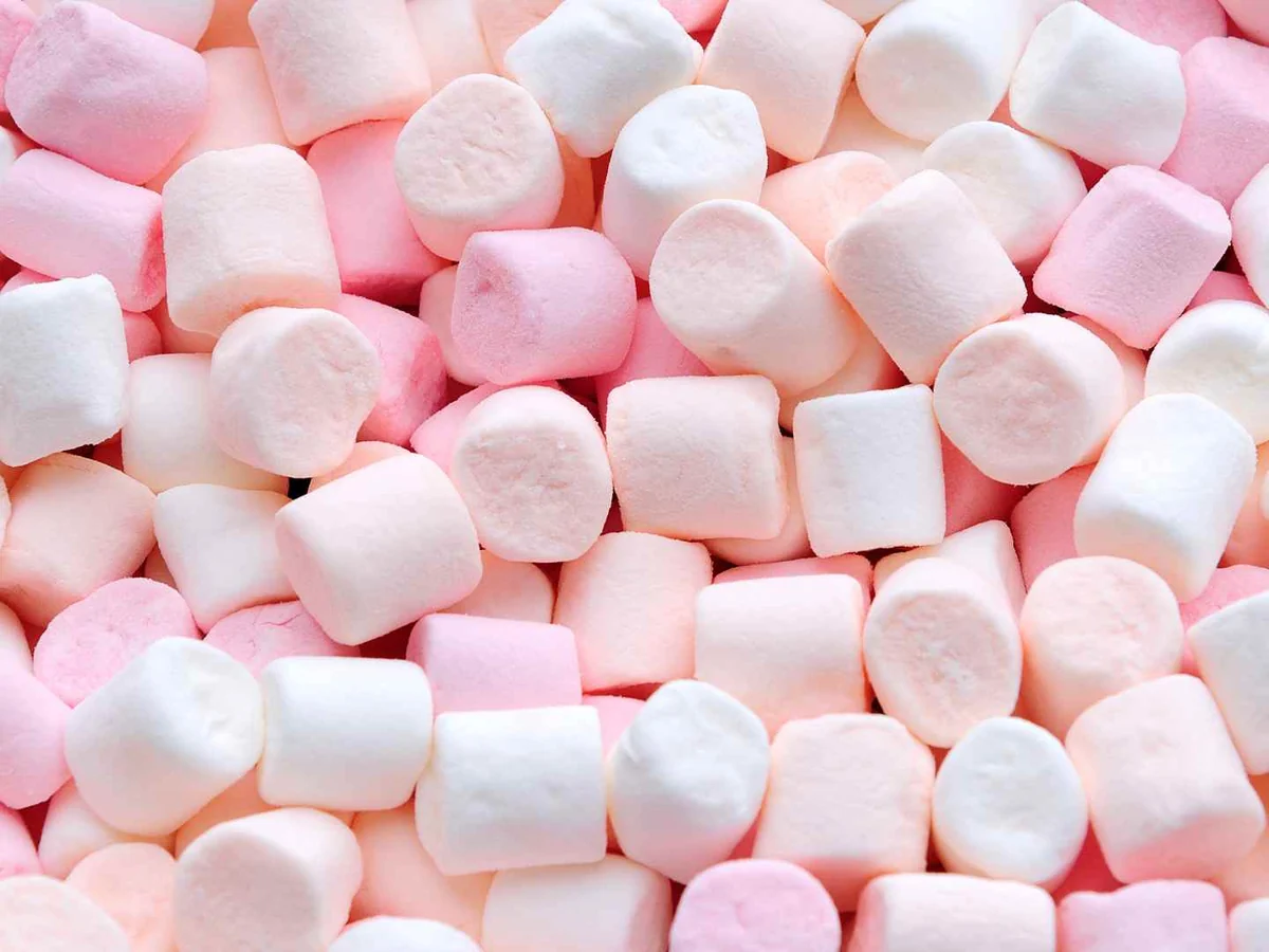 A frame filled edge to edge with small pink and white marshmallows