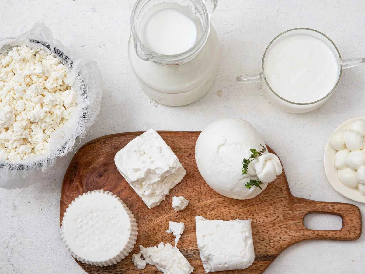 Shredded white mozzarella piled in a white bowl.