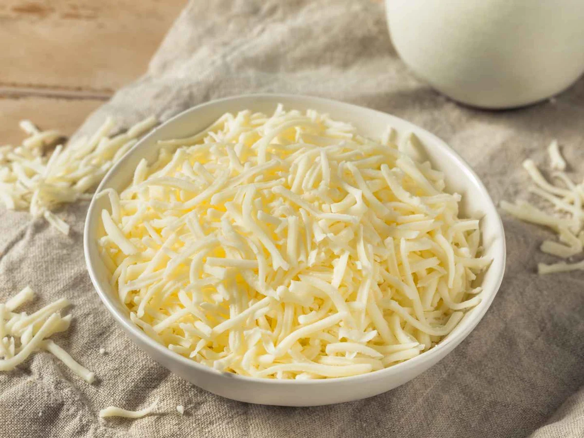 Milk, soft white cheeses, mozzarella balls, and curds arranged overhead.
