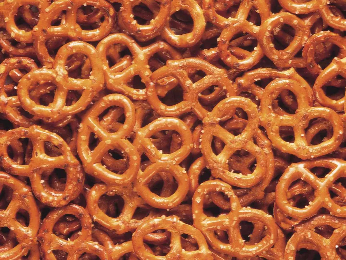 Glossy hard pretzel twists with one small stacked tower.