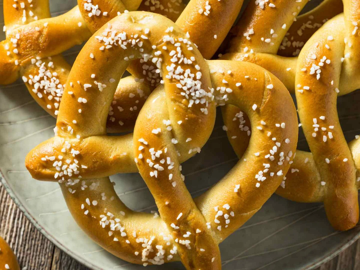 Salted hard pretzel twists overlapping across the frame.