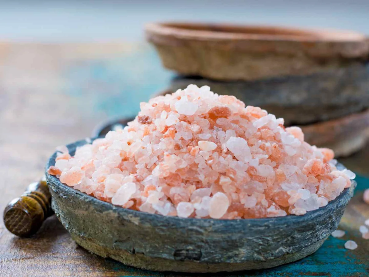 Pink salt crystals in a ceramic bowl
