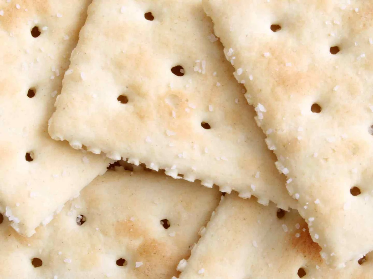 A close pile of salted square crackers