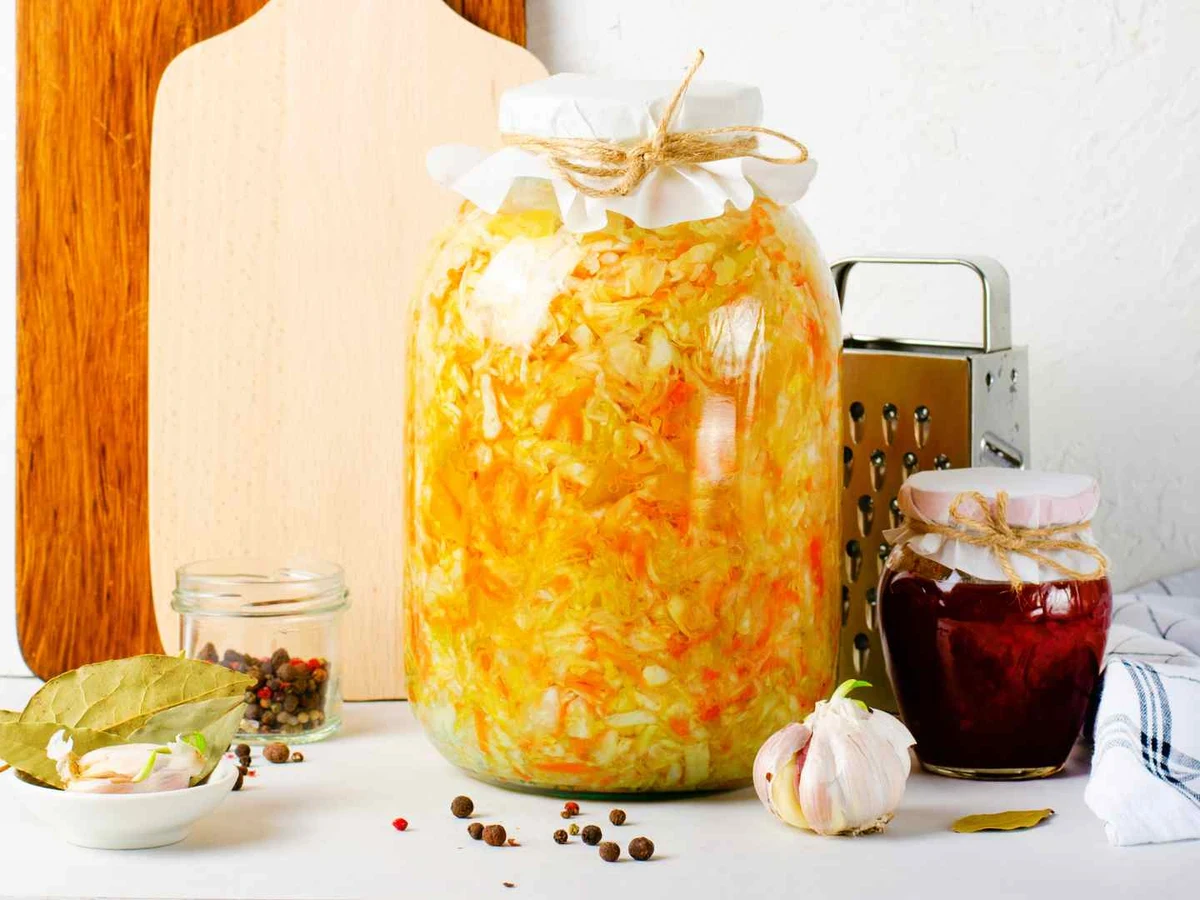 A bowl of sauerkraut with garlic and oil visible around it.