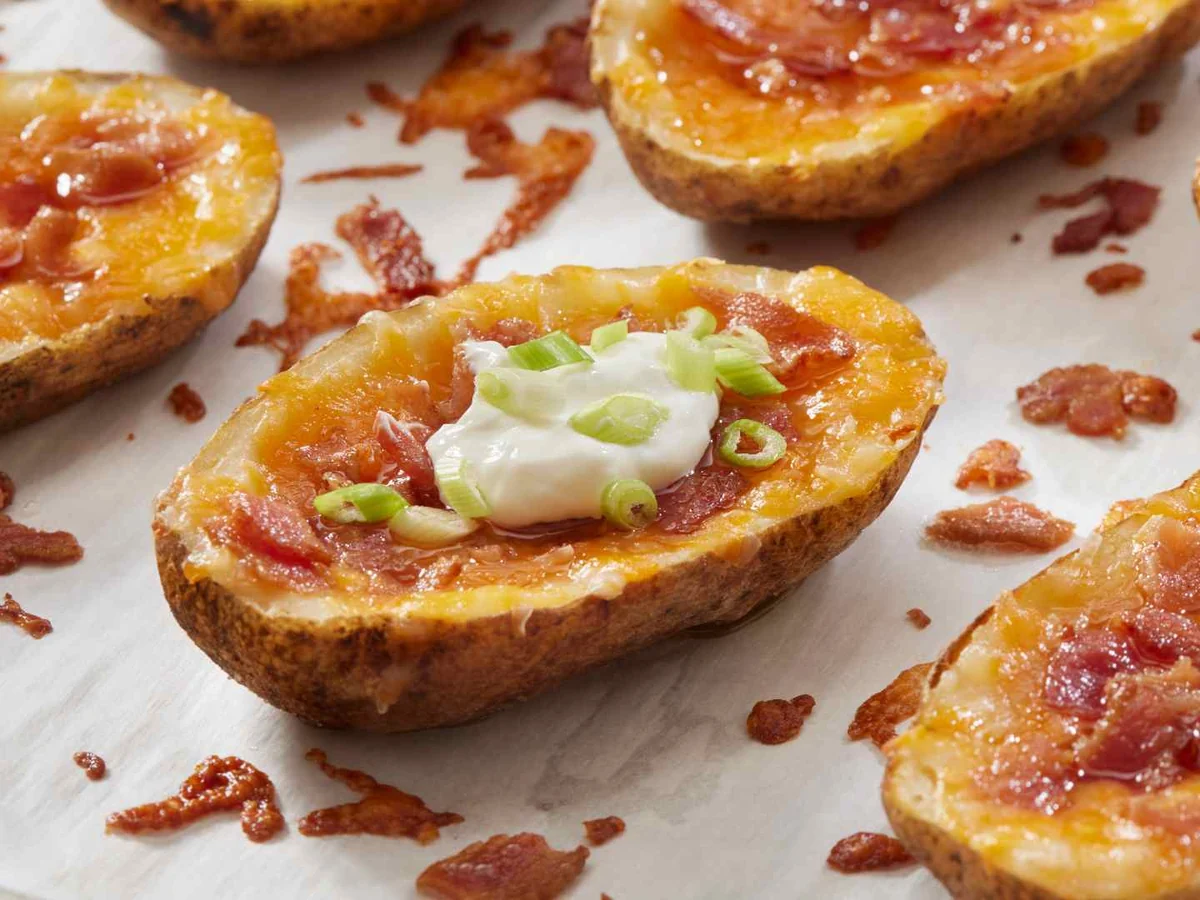 Loaded sweet potato skins topped with cheese, bacon, and cream