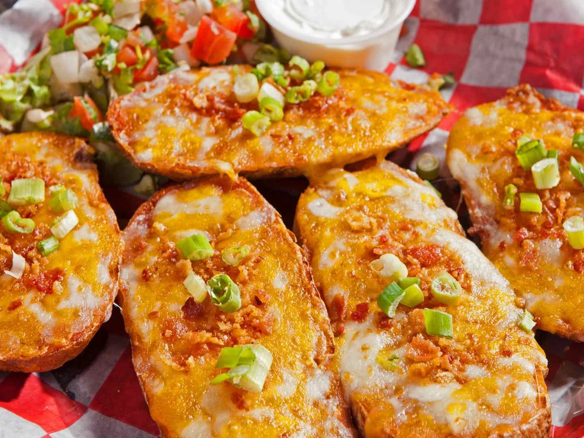 Loaded sweet potato skins on a red-lined serving basket
