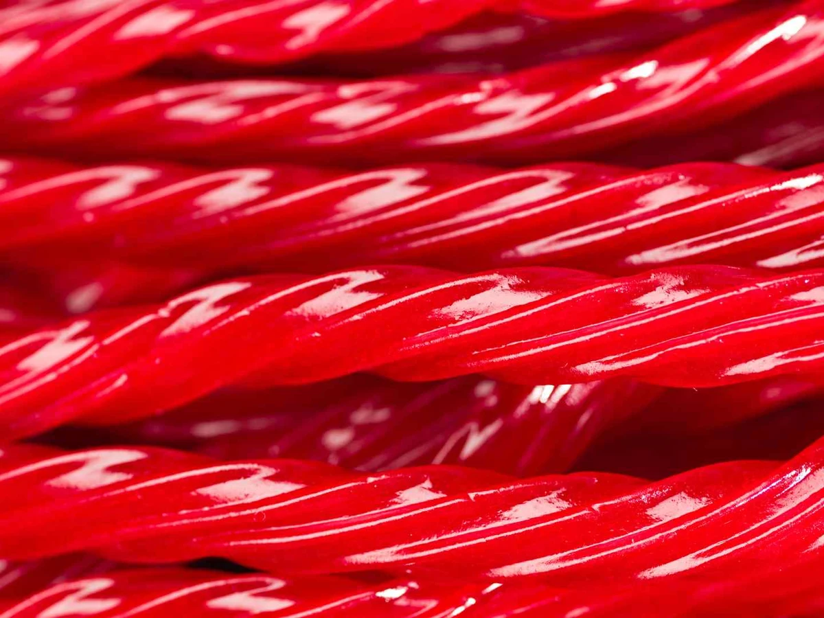 Glossy red twisted licorice sticks fill the frame.