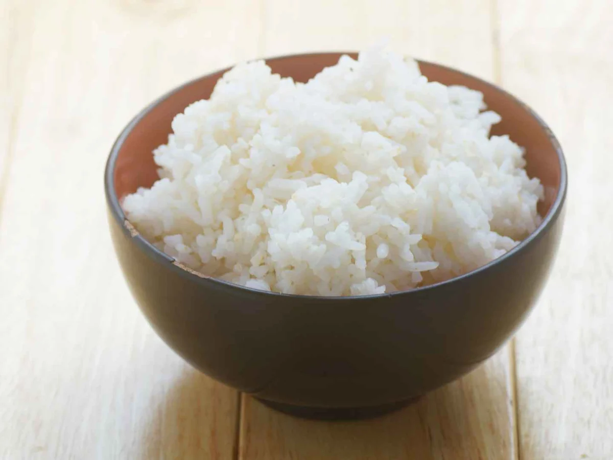A brown bowl filled with cooked white rice