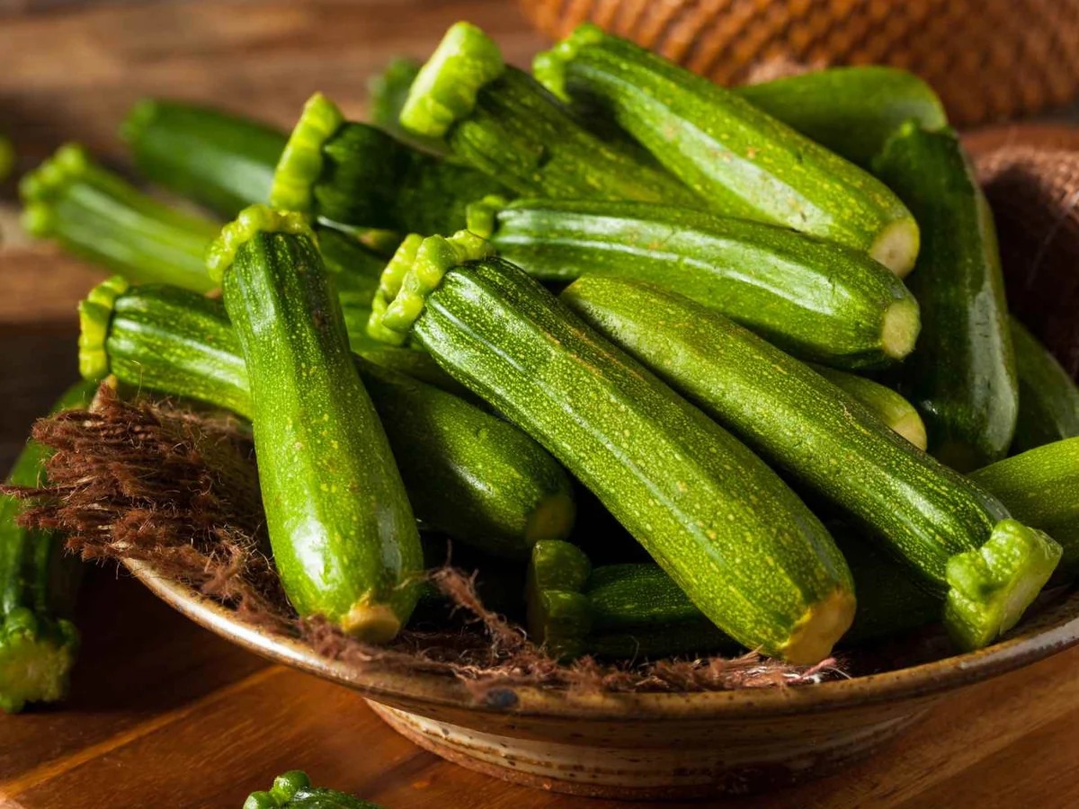 A bowl filled with whole small zucchini