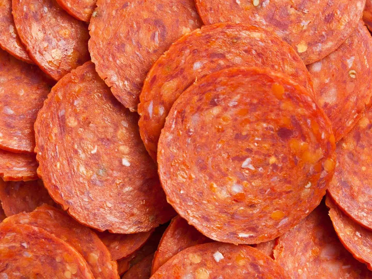 Close-up pile of round pepperoni slices