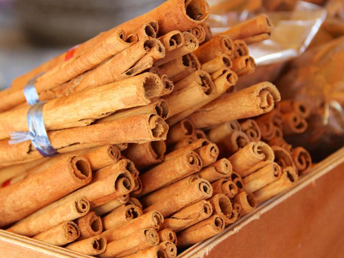 Bundled cinnamon sticks arranged on a wooden surface