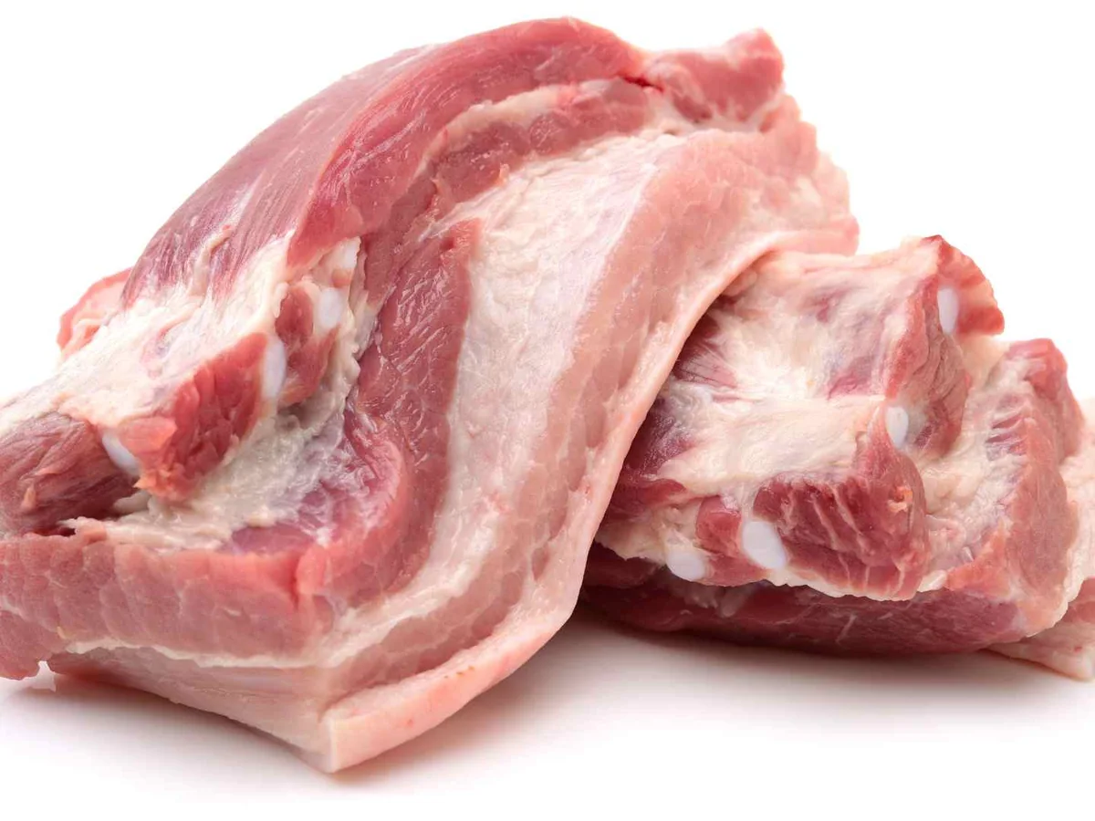 Raw bone-in pork pieces isolated on white