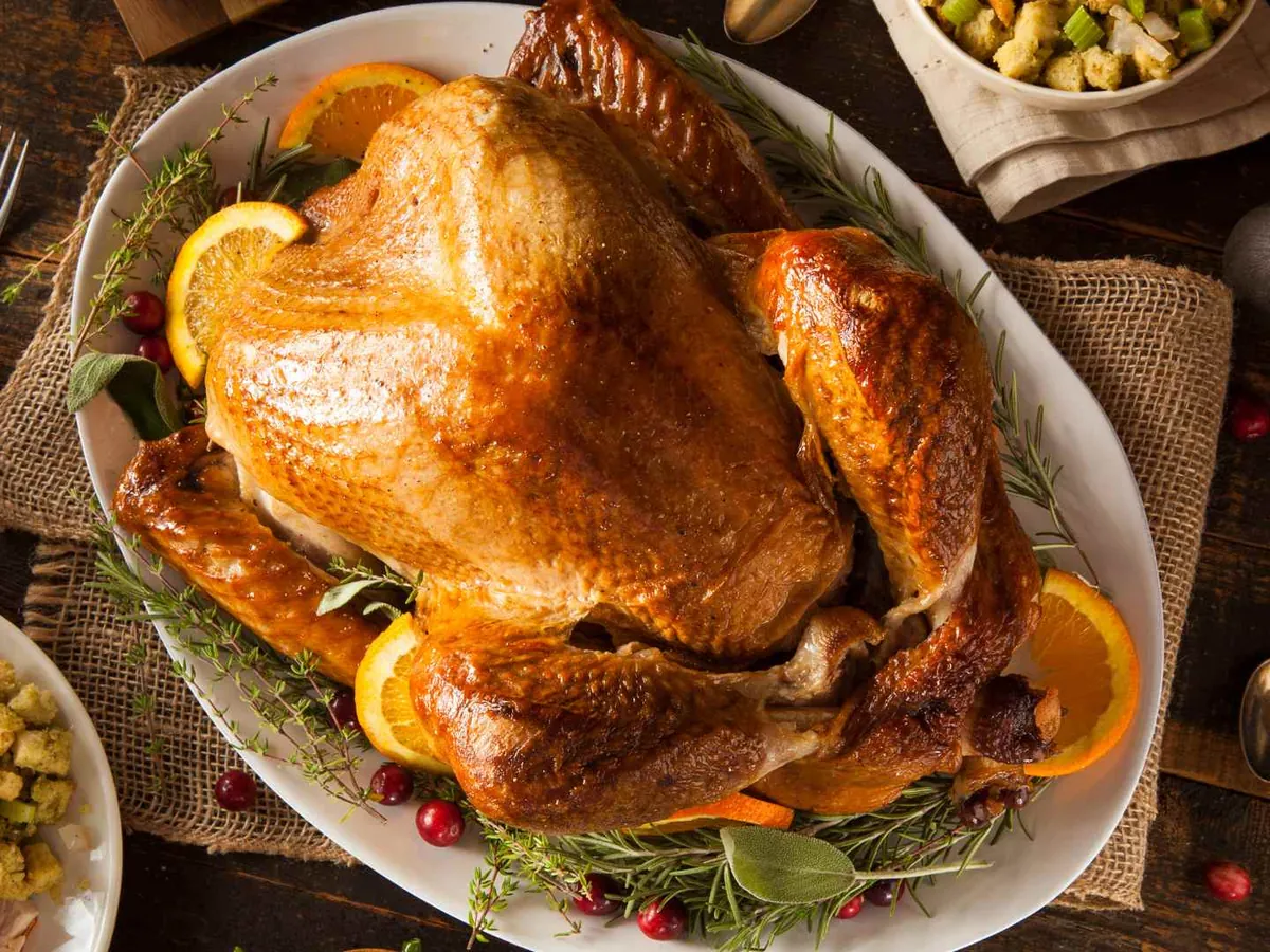 An overhead view of a roasted turkey with side dishes