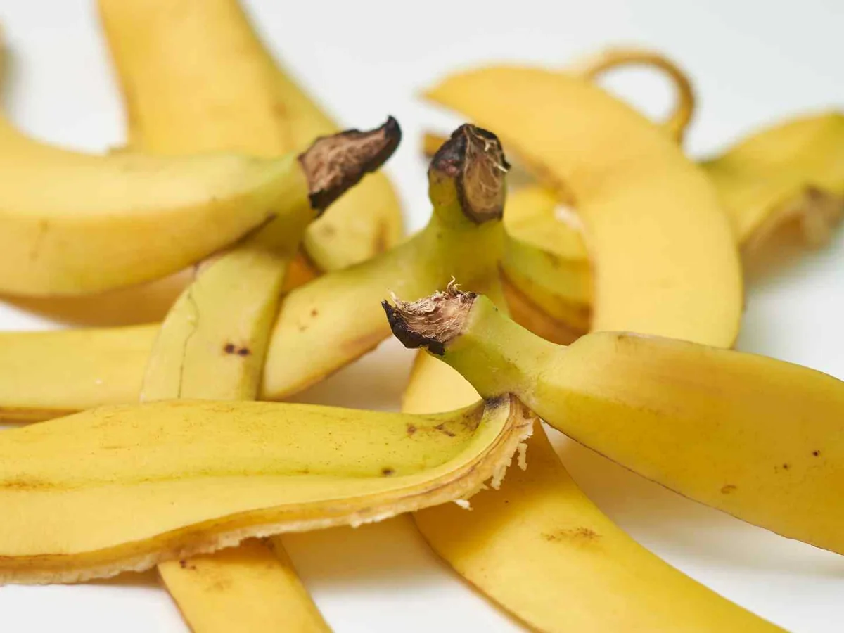 Several yellow banana peels overlapping on white