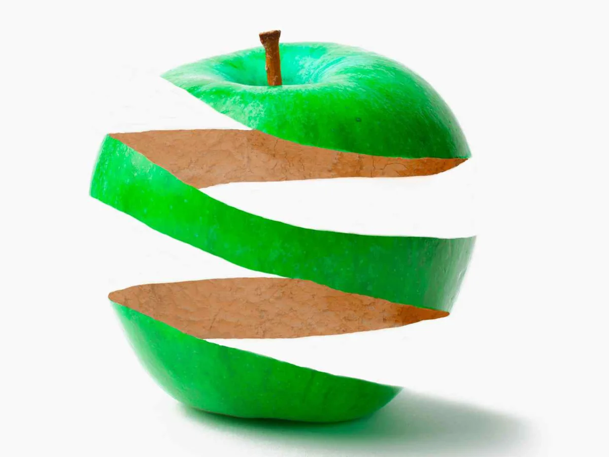 A stylized green apple separated by a spiral strip of peel