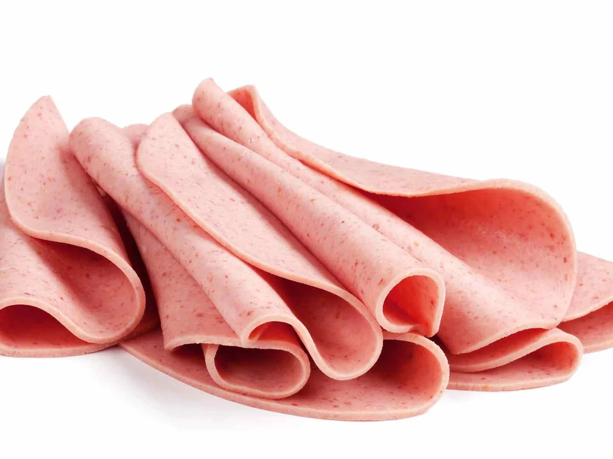 Folded pink bologna slices isolated on white