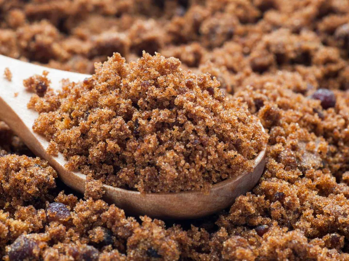 Moist brown sugar with a wooden scoop