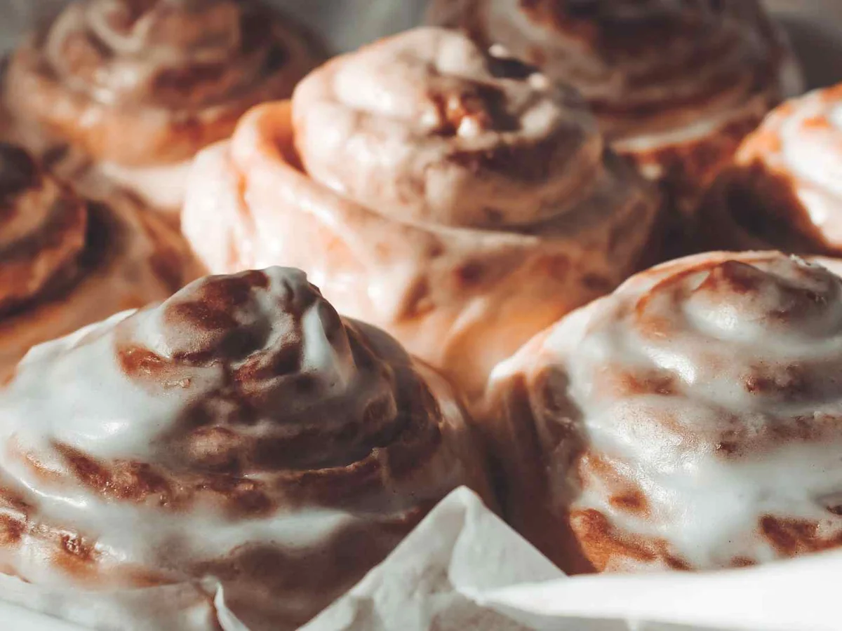 Close-up of heavily iced cinnamon rolls