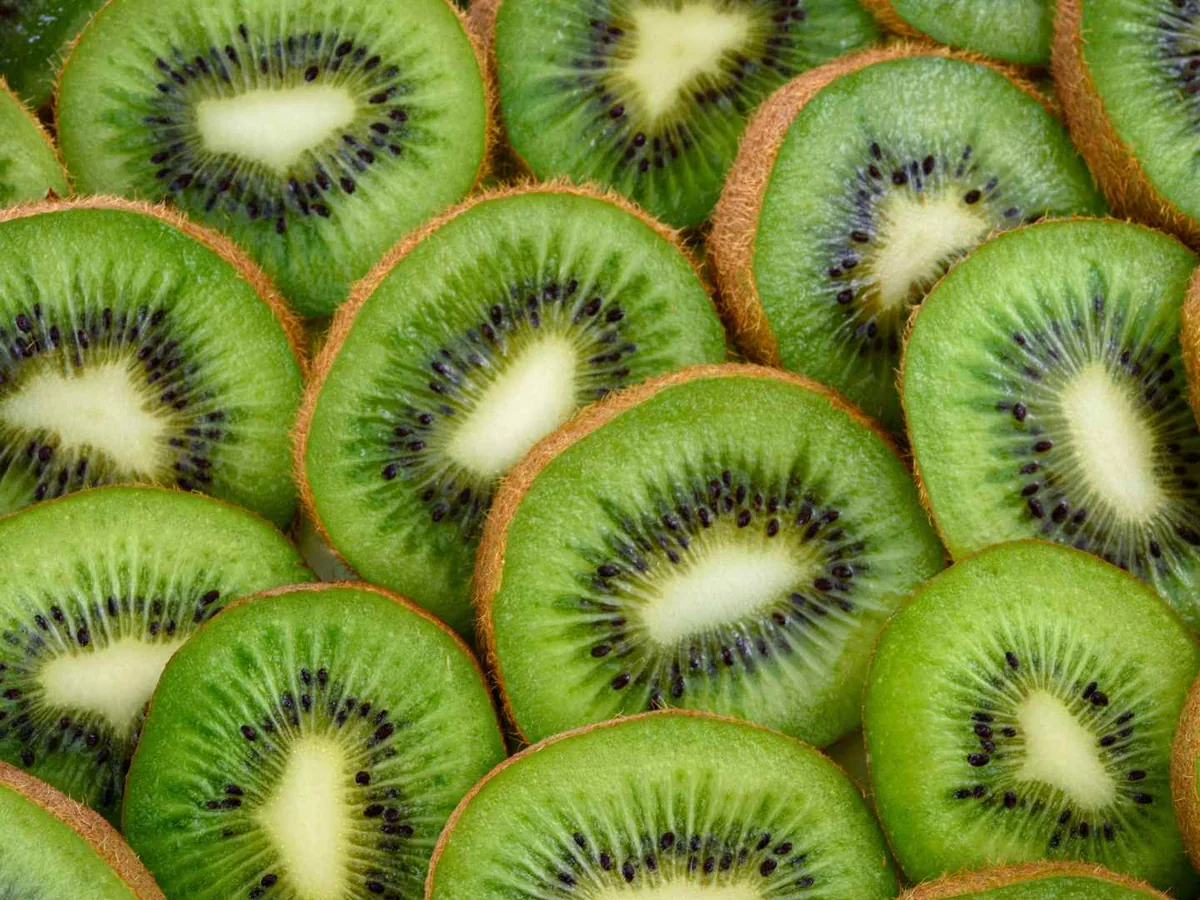 Rows of sliced kiwi fruit filling the frame