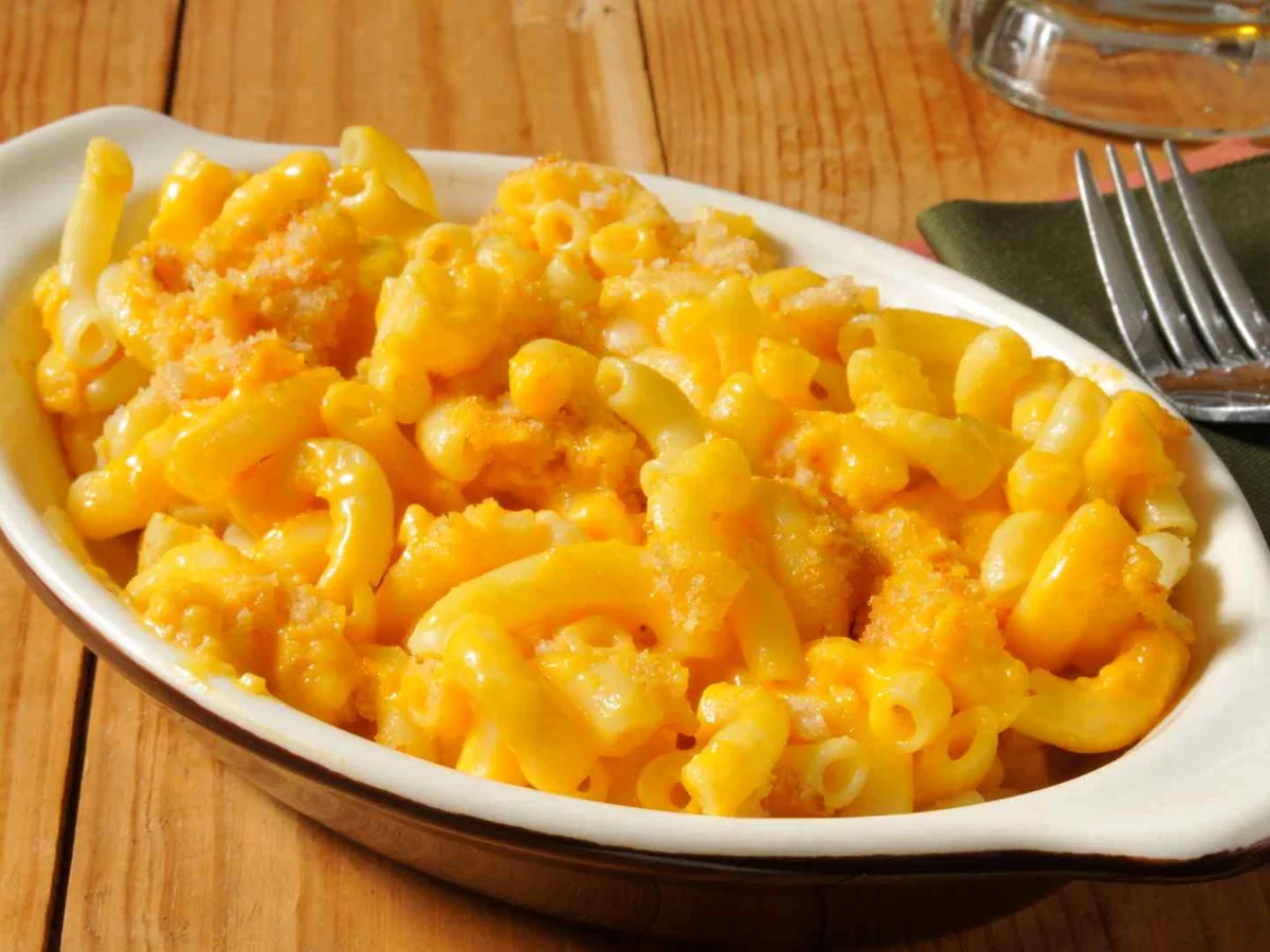 Bright orange macaroni and cheese in a white baking dish