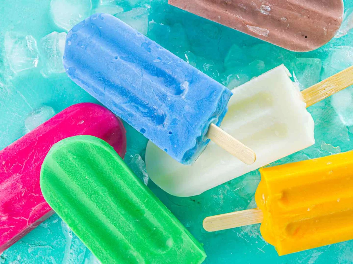 Bright multicolored popsicles lying on crushed ice