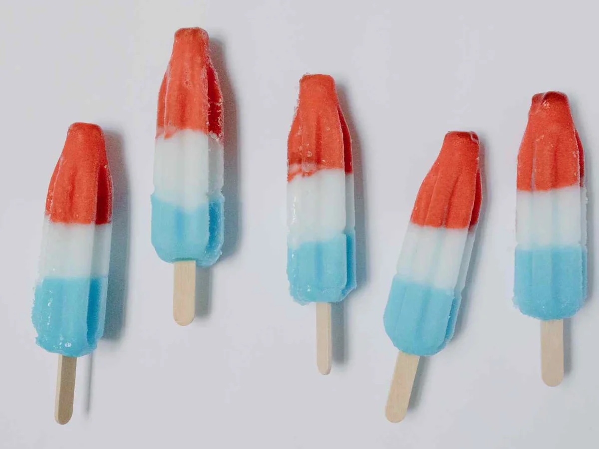 Red, white, and blue popsicles arranged on gray