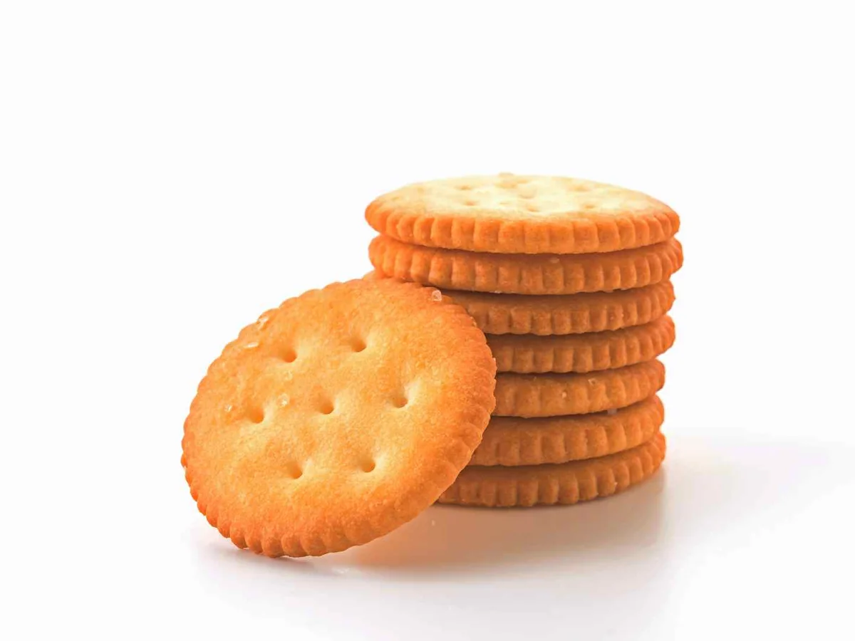 A stack of round buttery crackers isolated on white