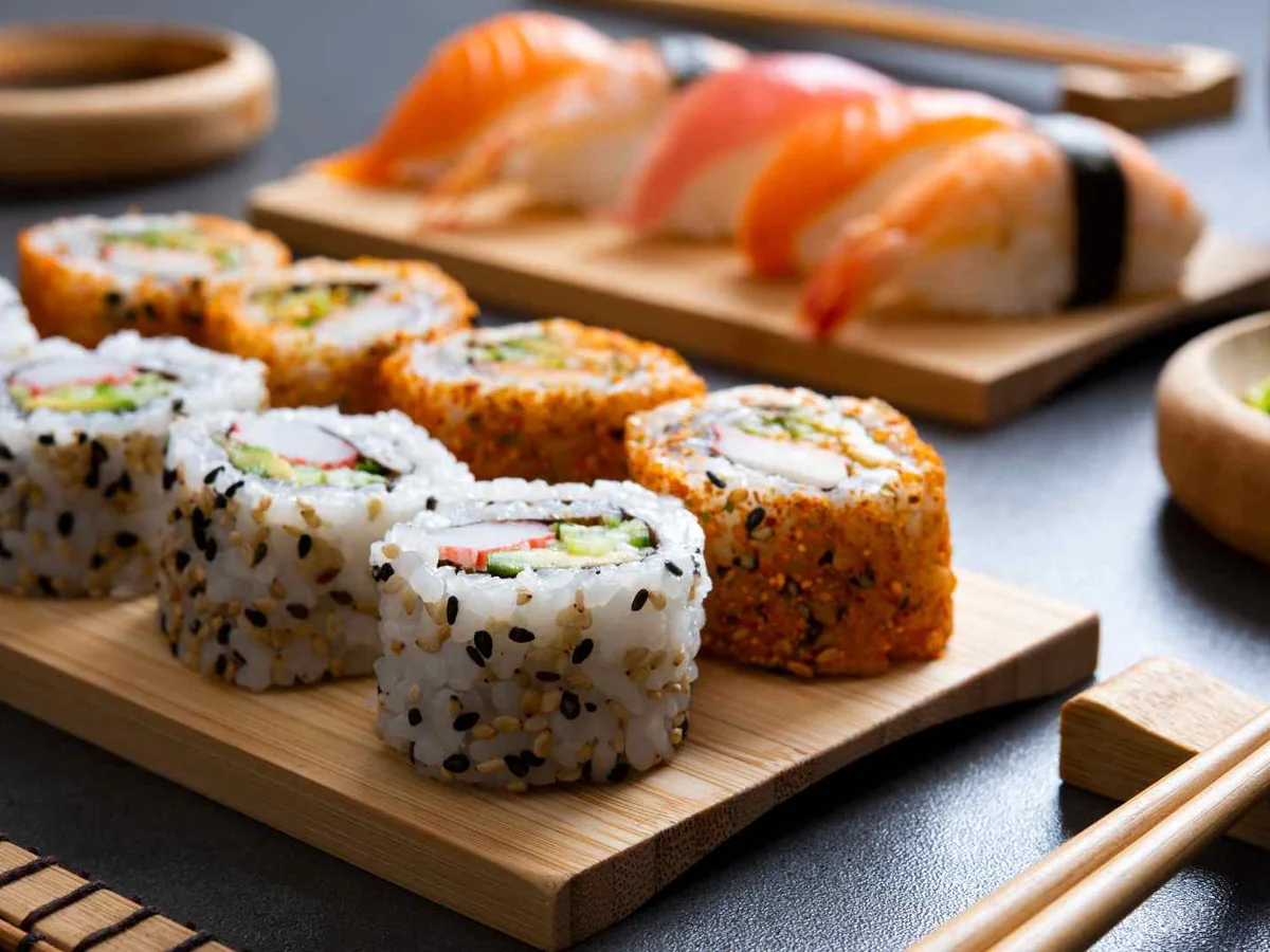 Assorted sushi rolls and nigiri on a wooden serving board