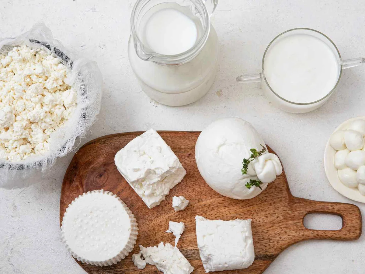 Assorted white dairy foods and milk viewed from above